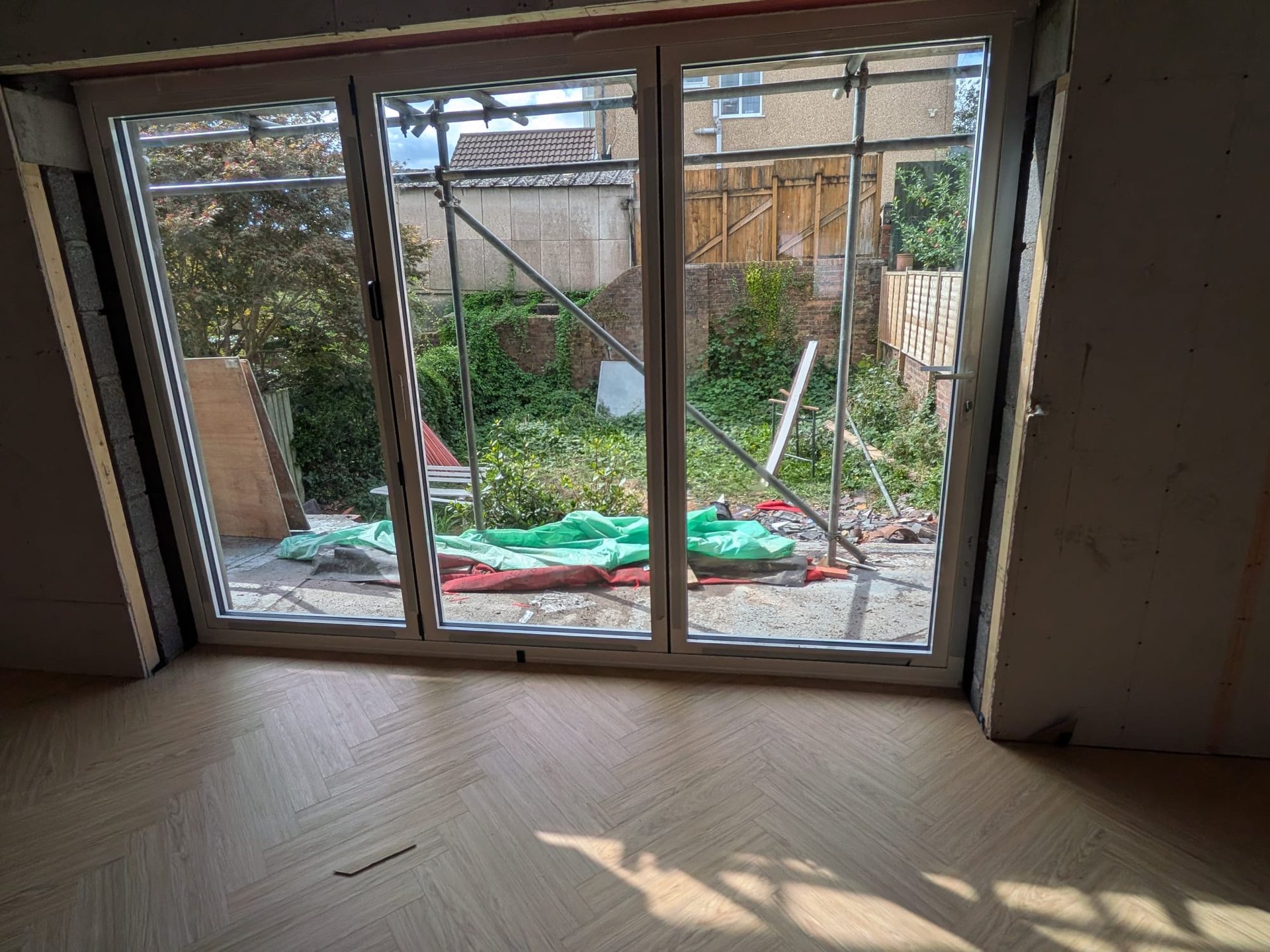 Bi-fold doors fitted with herringbone LVT flooring